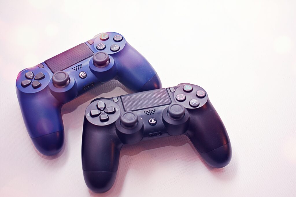 Sony ps4 wireless controllers on white surface
